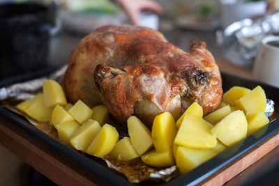 Close-up of potatoes and chicken meat in tray