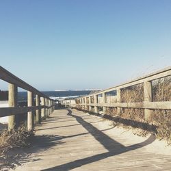 View of walkway along calm sea