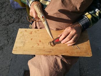 Midsection of leather craftsperson working at workshop