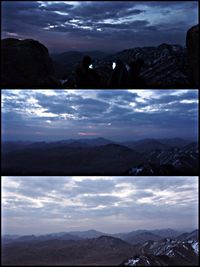Scenic view of mountains against cloudy sky
