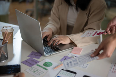 Midsection of business colleagues working at office