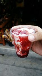 Close-up of hand holding ice cream