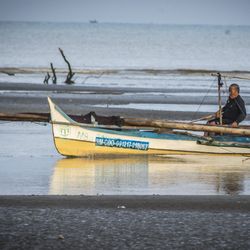 Man on beach against sky