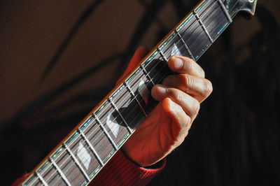 Cropped image of man playing guitar