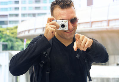 Portrait of young man photographing