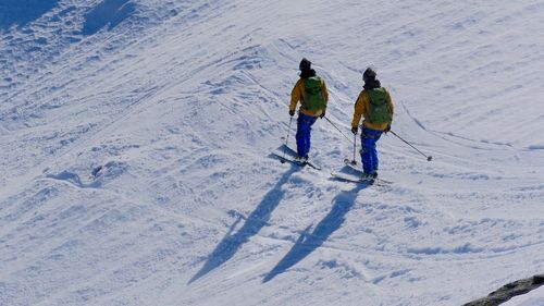 Full length rear view of boys on sunny day
