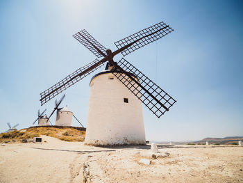 Low angle view of traditional windmill against sky