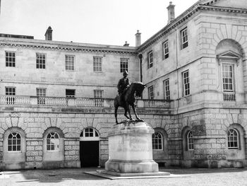 Statue against historic building