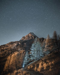 Scenic view of landscape against sky at night