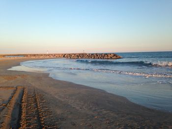 Scenic view of beach against clear sky