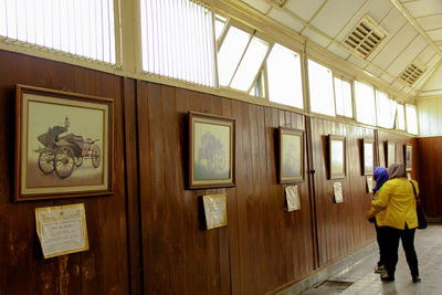 Full length rear view of woman walking on wall