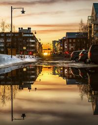 City street against sky during sunset