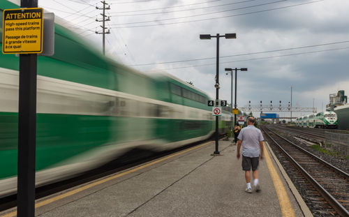 Train at railroad station platform against sky