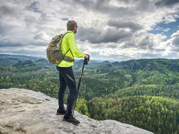 Tourist with backpack hike on mountain trek. trekking in mountains. sharp exposed sandstone hills.