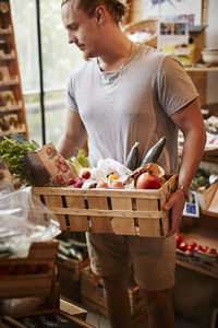 Man doing shopping in shop with organic food