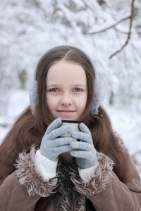 Portrait of a smiling girl in snow