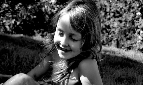 Close-up of smiling girl on grassy field