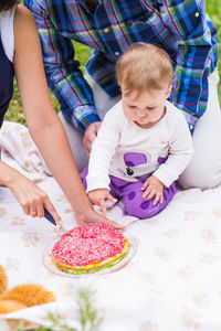 High angle view of woman and chocolate cake