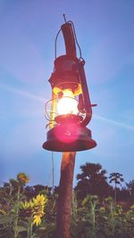 Low angle view of illuminated lights against blue sky