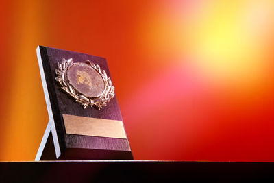 Close-up of trophy against yellow background