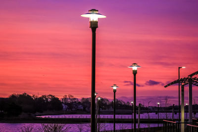 Street light against orange sky