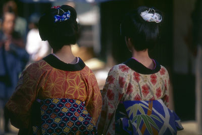 Rear view of women on footpath