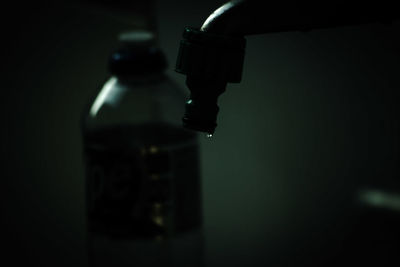 Close-up of water bottle against black background