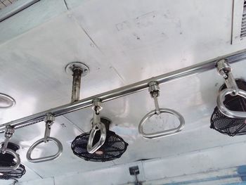 Low angle view of handles in train