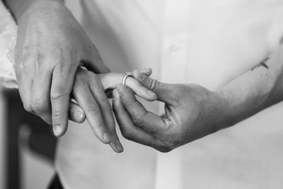 Close-up of couple holding hands