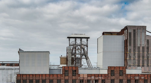 Low angle view of industrial building against sky