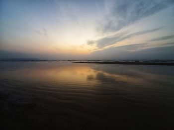 Scenic view of beach against sky during sunset