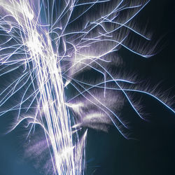 Close-up of fireworks against sky at night