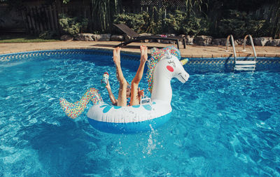 High angle view of girl swimming in pool