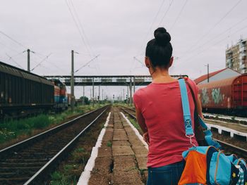 Woman standing on railroad track