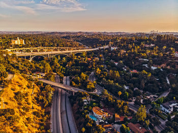 Aerial view of cityscape against sky during sunset