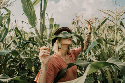 Woman standing by plants