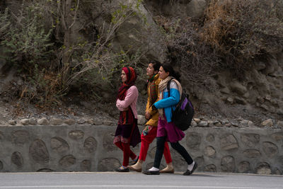 Rear view of people walking outdoors