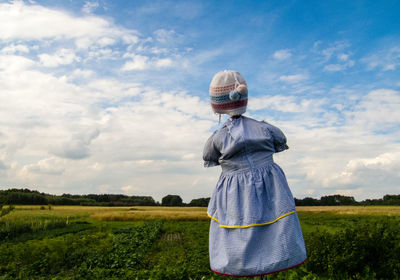 Scarecrow on field against sky