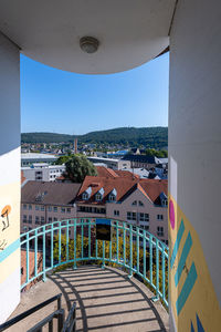 Buildings in city against clear blue sky