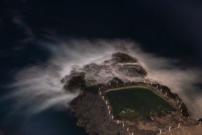 Aerial view of sea against cloudy sky