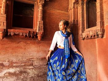 Tourist standing by historical building