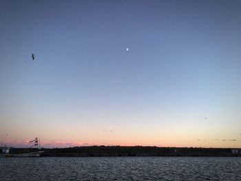 Scenic view of sea against clear sky during sunset