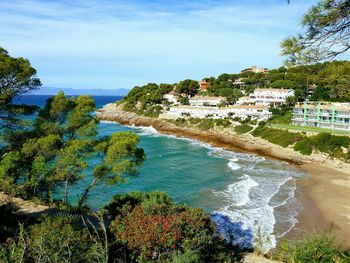 High angle view of trees by sea against sky