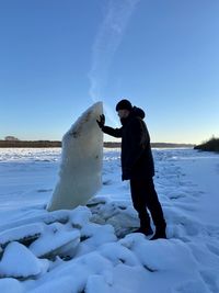 Full length of man standing on snow covered land