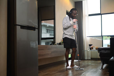 Rear view of young woman standing in bathroom