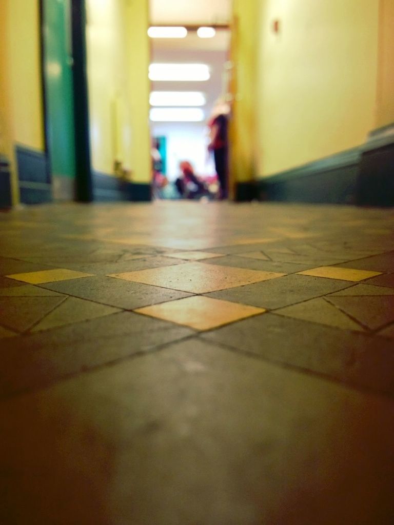 indoors, selective focus, surface level, architecture, built structure, flooring, focus on foreground, building exterior, empty, incidental people, the way forward, no people, floor, close-up, shadow, day, corridor, illuminated, wall - building feature, sunlight