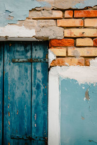 Close up of window and ruined wall of ancient house in burano