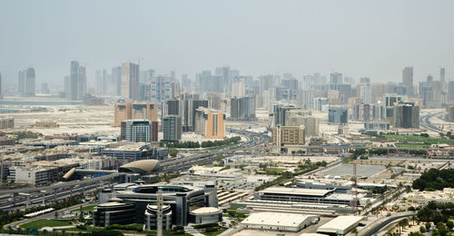 High angle view of buildings in city against sky