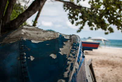 Close-up of boat moored on beach