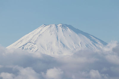 Low angle view of snowcapped mountain against sky